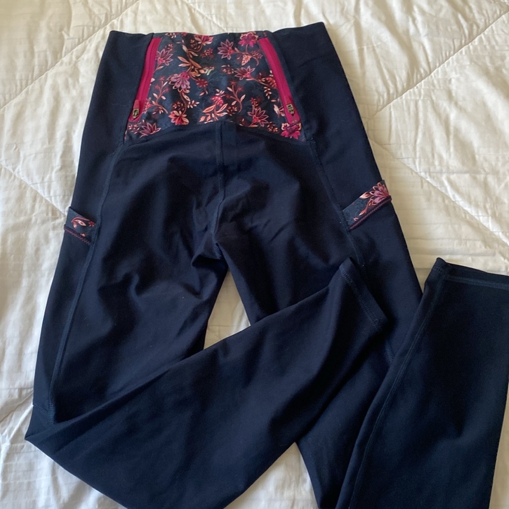 pink and purple floral and navy workout leggings with many pockets